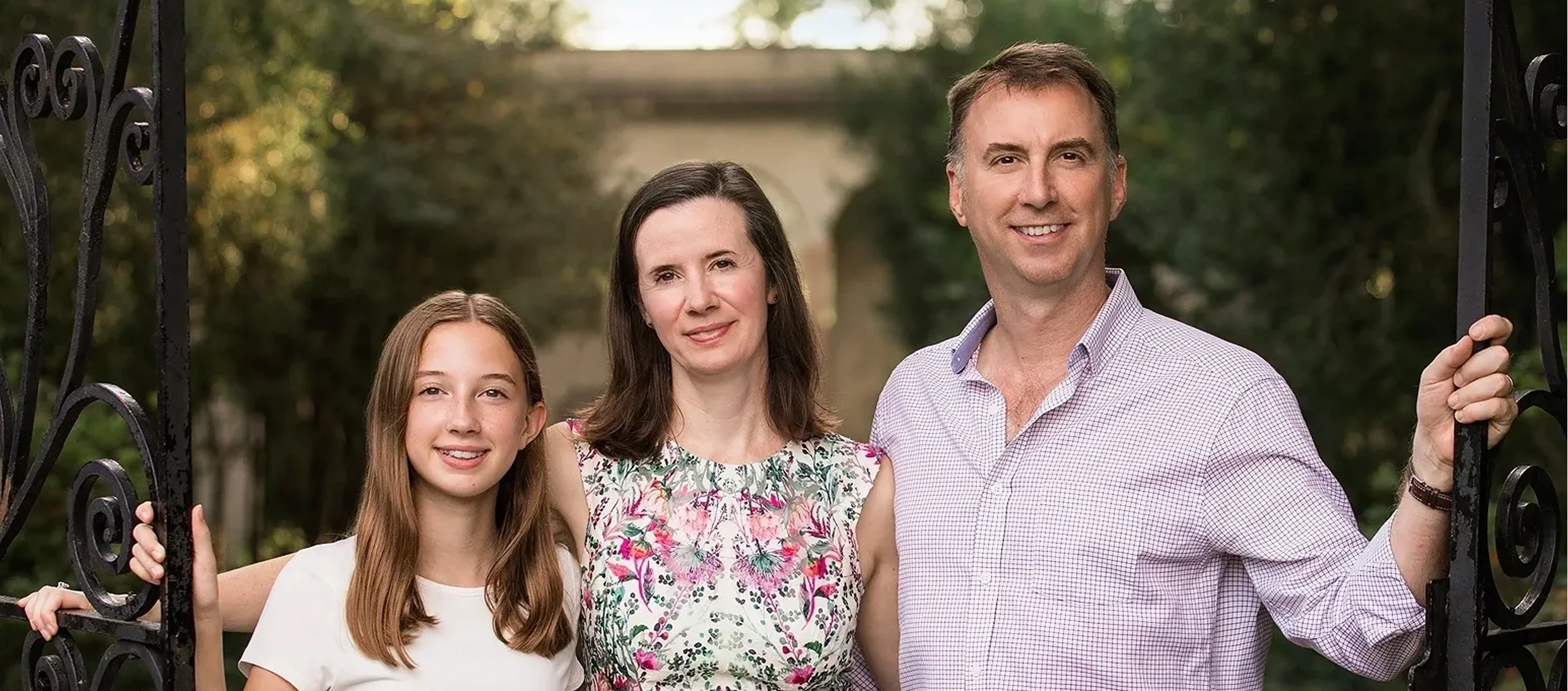 Smiling family posing outdoors